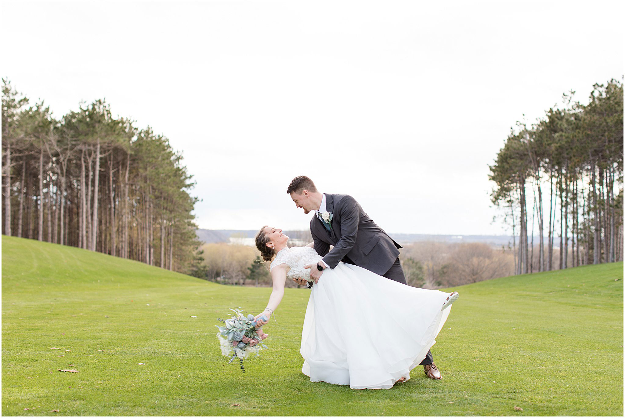 Groom dipping bride during wedding photos – golf club wedding venue