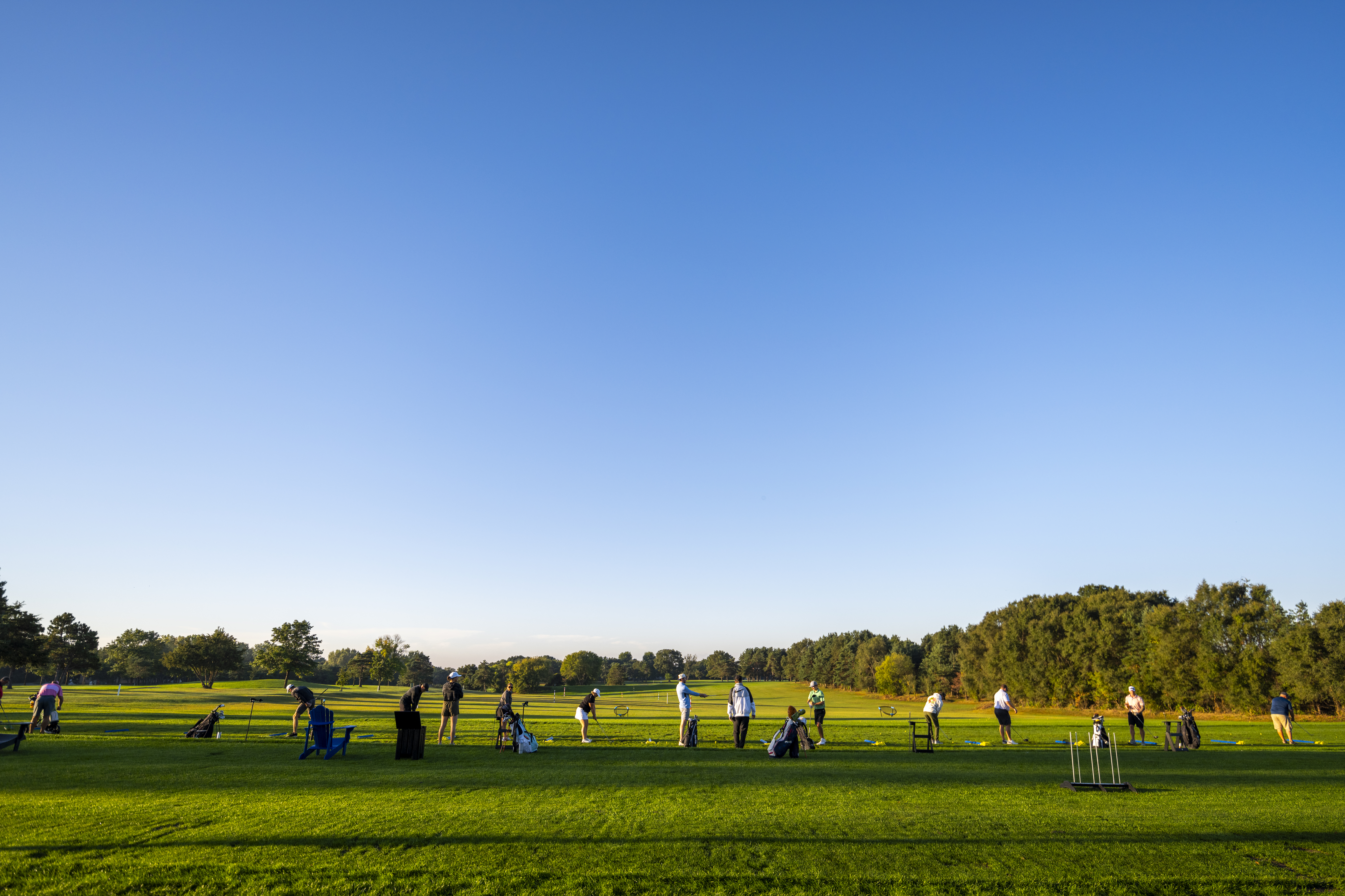 Golfers practicing on the driving range at River Oaks Golf Course in Cottage Grove Minnesota