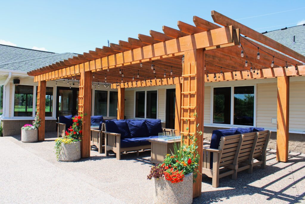 Outdoor patio lounge with pergola seating and string lights at River Oaks Golf Course and Event Center in Cottage Grove Minnesota